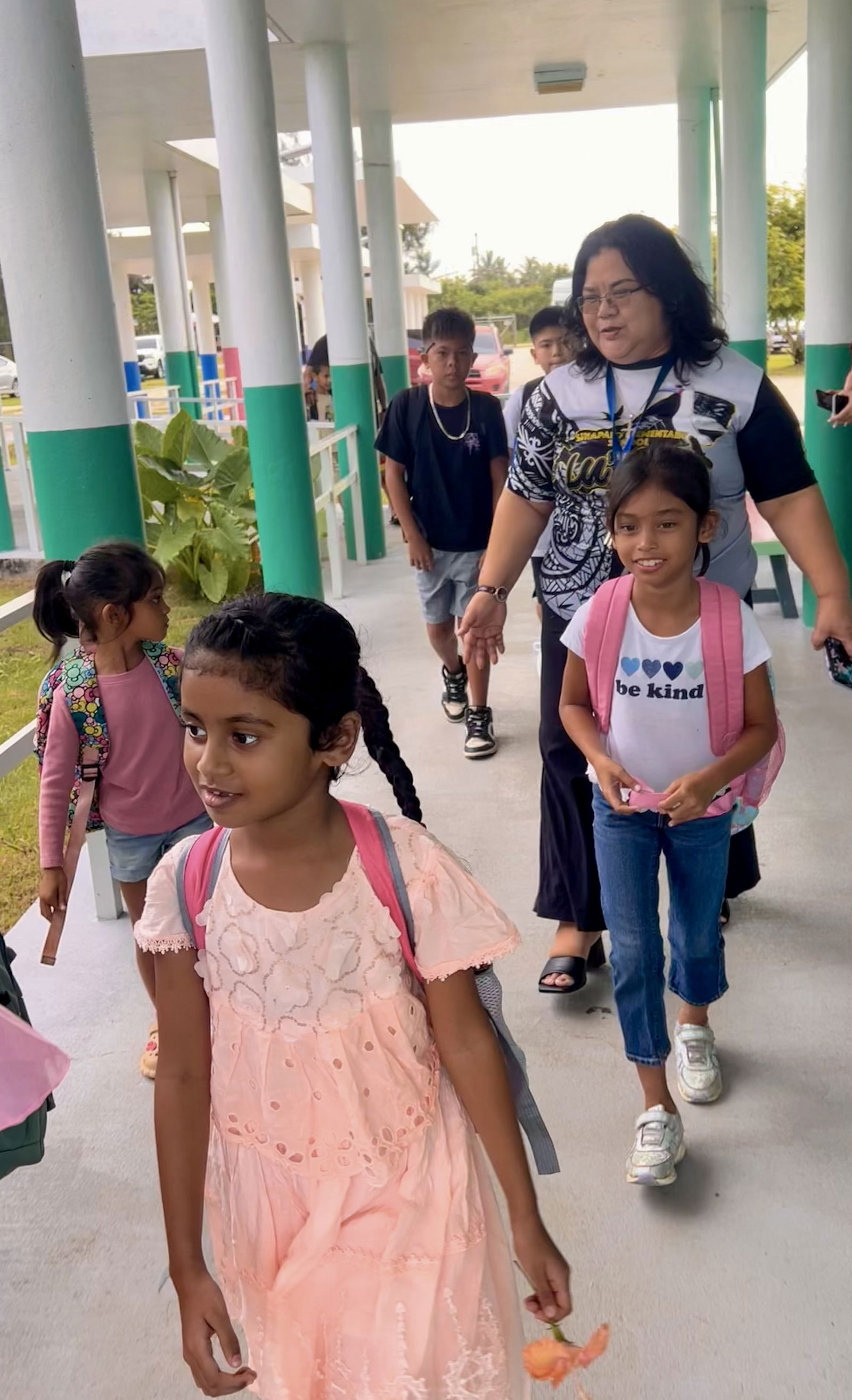 Sinapalo Elementary School Principal Daisy Quitugua with returning students.