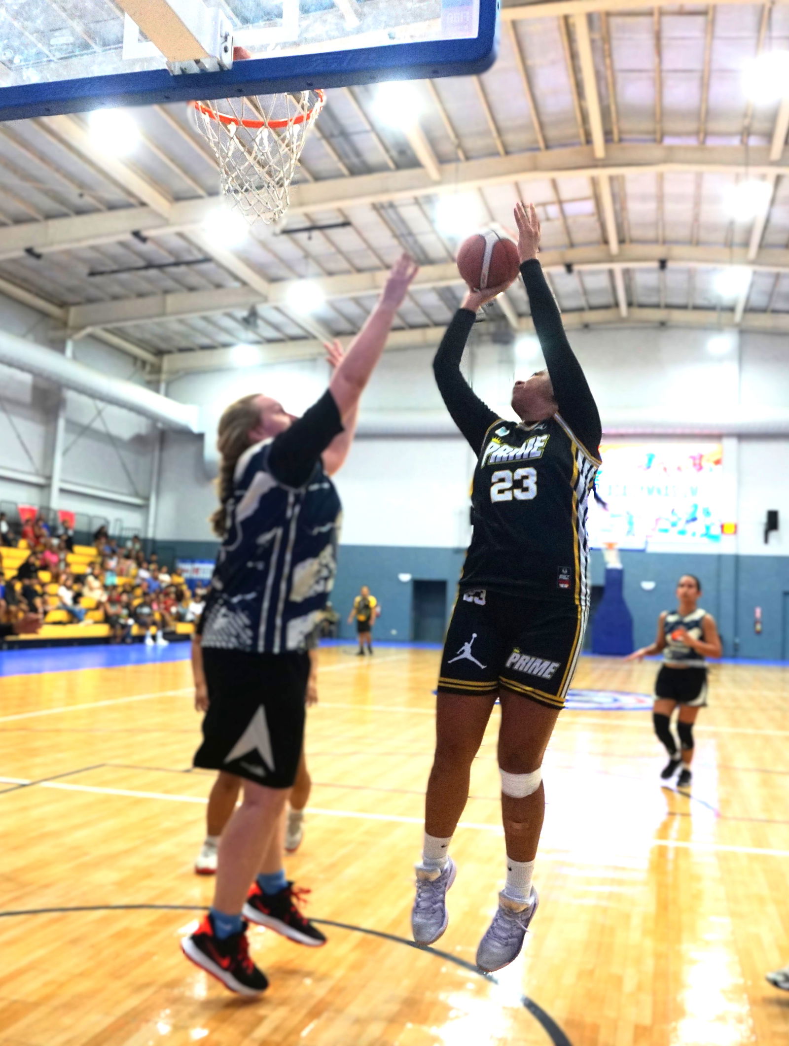 Prime's Azriel Fatialofa takes the contested shot against the Hericanes in the women's division of the 2025 Allied Pacific Environmental Consulting Basketball League at the Ada gym on Thursday night.Photo by James F. Sablan Jr.