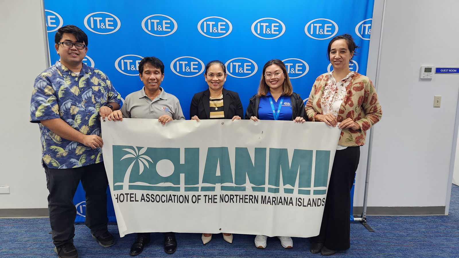 IT&E Executive Director Velma Palacios, center, presents a Samsung S24 Ultra 512 GB on July 24, 2025, at the company office in Susupe, Saipan, to the organizing committee of the 23rd Annual HANMI Charity Classic Golf Tournament. The tournament will be held on Aug. 9, 2025, at LaoLao Bay Golf & Resort.  From left, tournament committee member Lourence Camacho and chairman William Retardo, ITE’s Palacios and junior marketing coordinator Charisse Ramos and tournament committee member Catherine Perry.HANMI photo
