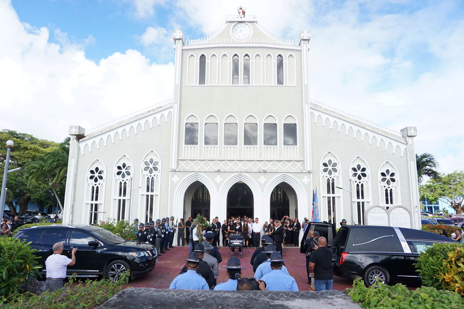 First Lady Wella Palacios and her family follow Gov. Arnold I. Palacios’ casket to the hearse after the Christian Mass at Mount Carmel Cathedral.