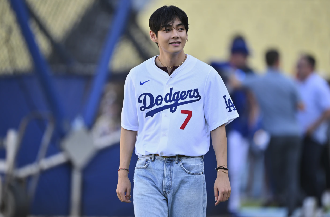 V, a member of the South Korean K-pop band BTS, looks on during batting practice before a baseball game between the Los Angeles Dodgers and the Cincinnati Reds on Monday, Aug. 25, 2025, in Los Angeles.AP