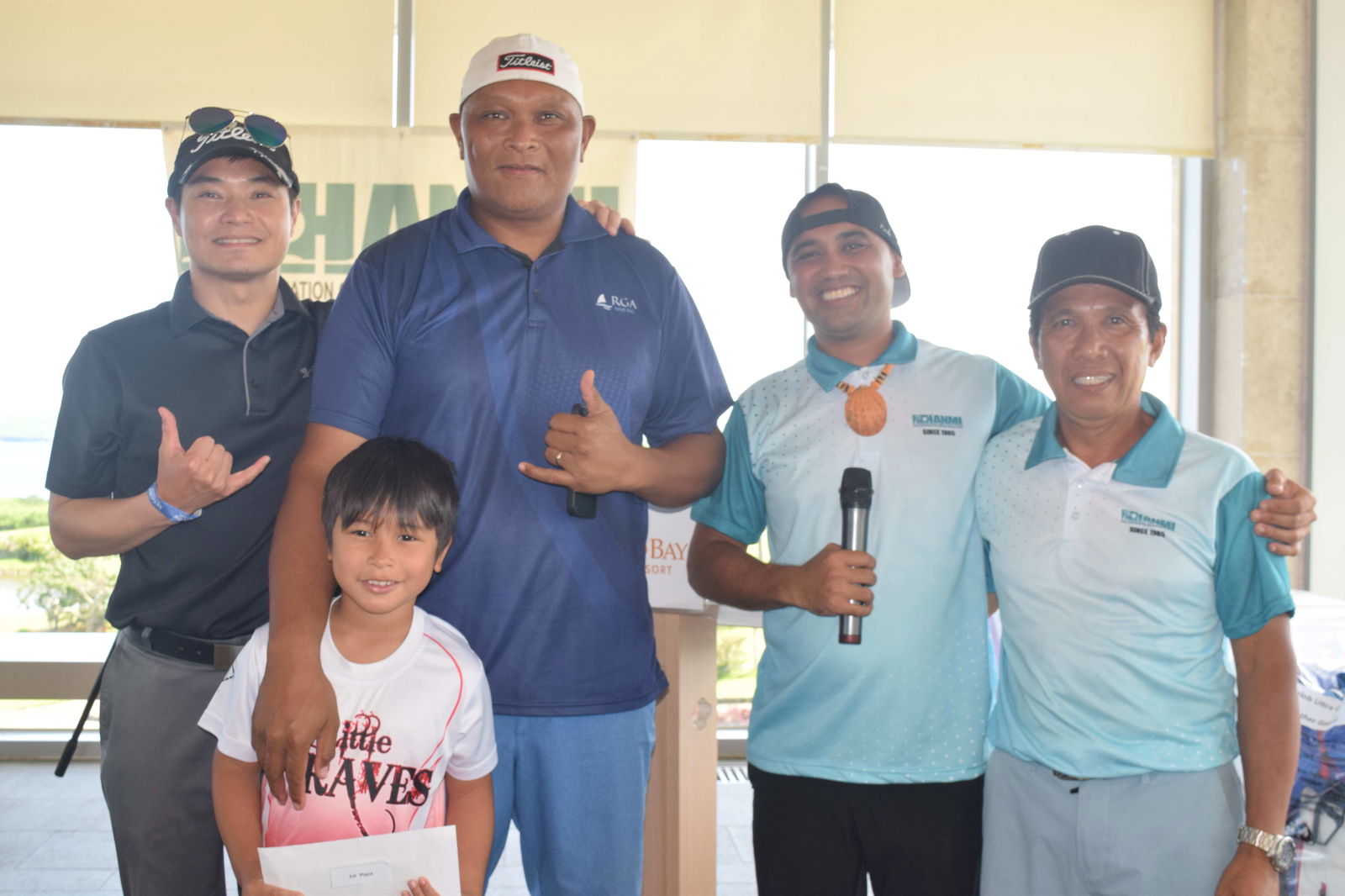 Ned Norita, with his son Avawn Jacob (holding the cash prize), poses for a photo with HANMI Chair Dennis Seo, tournament committee member Franco Santos, and tournament committee chair William Retardo during the awards ceremony at LaoLao Bay Golf & Resort on Saturday.Photo by Emmanuel T. Erediano