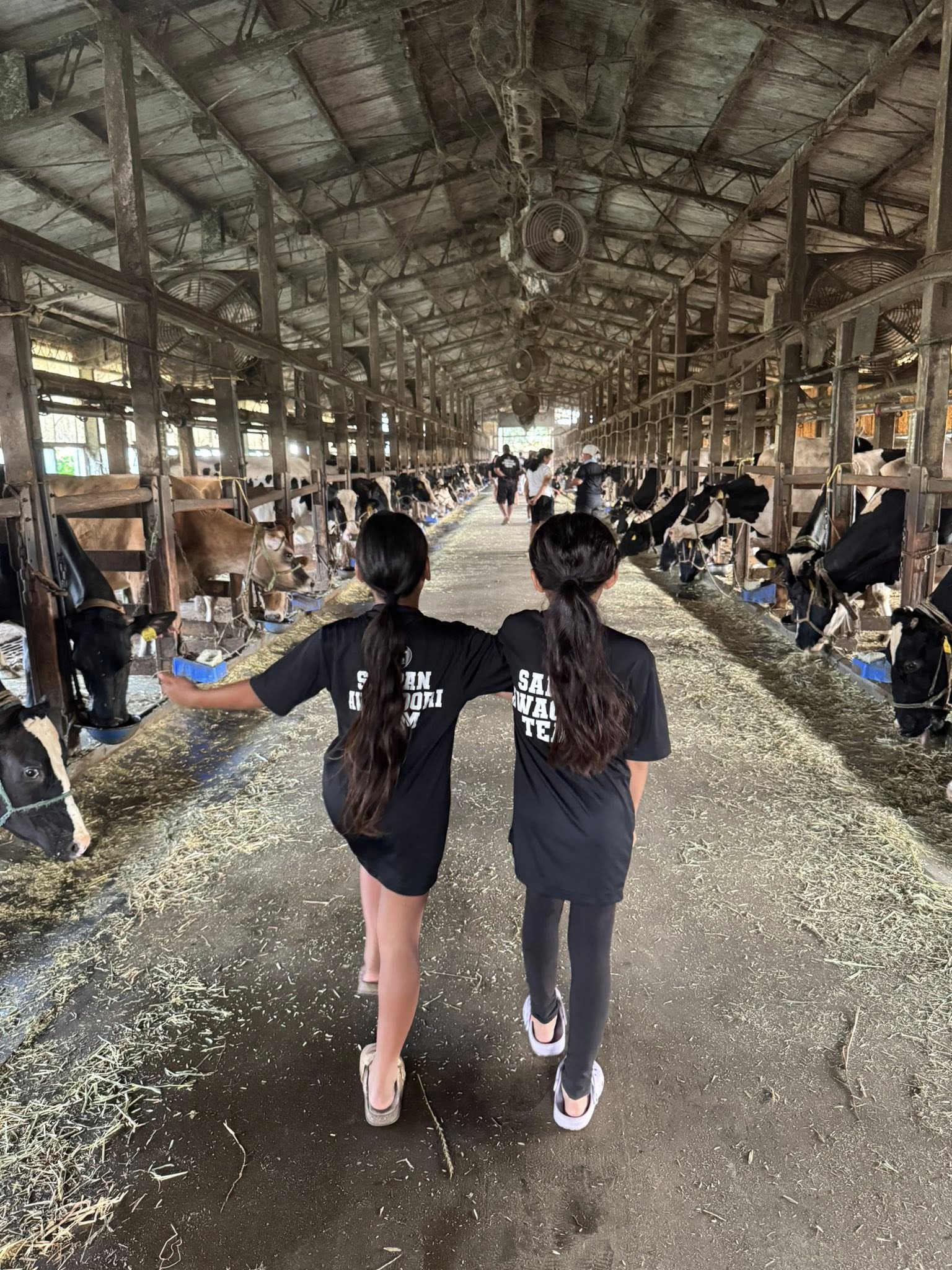 Two of the Saipan Awaodori Team members at a milk farm in Noda City.