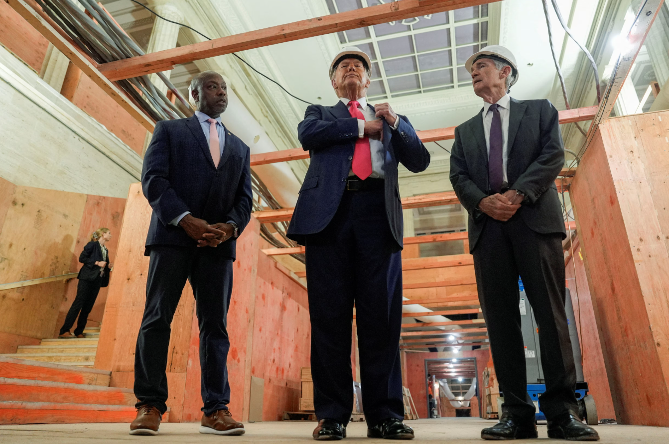 President Donald Trump, U.S. Sen. Tim Scott, R-SC, and Federal Reserve Chair Jerome Powell react during a tour of the Federal Reserve Board building, which is currently undergoing renovations, in Washington, D.C., July 24, 2025.REUTERS