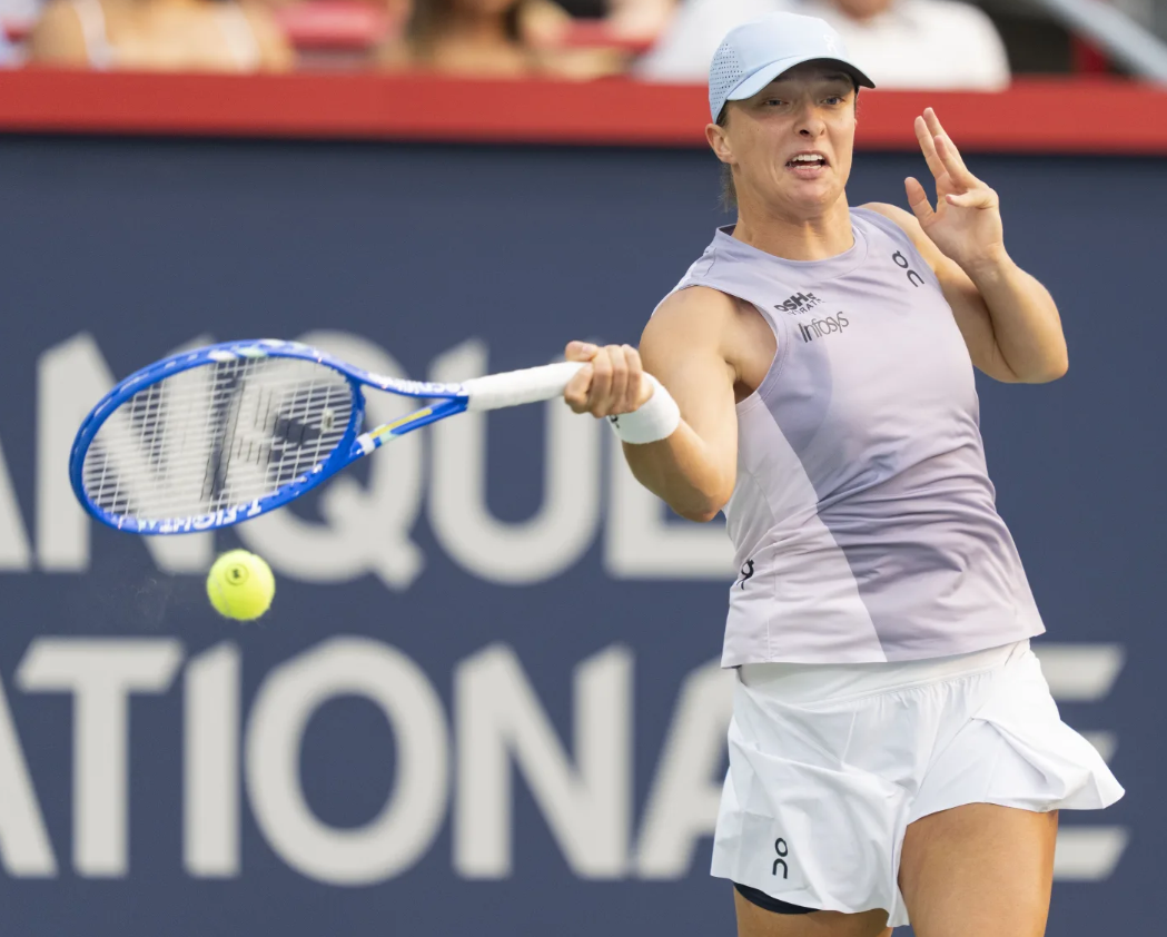 Iga Swiatek of Poland hits a return to Clara Tauson of Denmark during their round-of-16 match at the National Bank Open women’s tennis tournament in Montreal on Aug. 3, 2025.AP