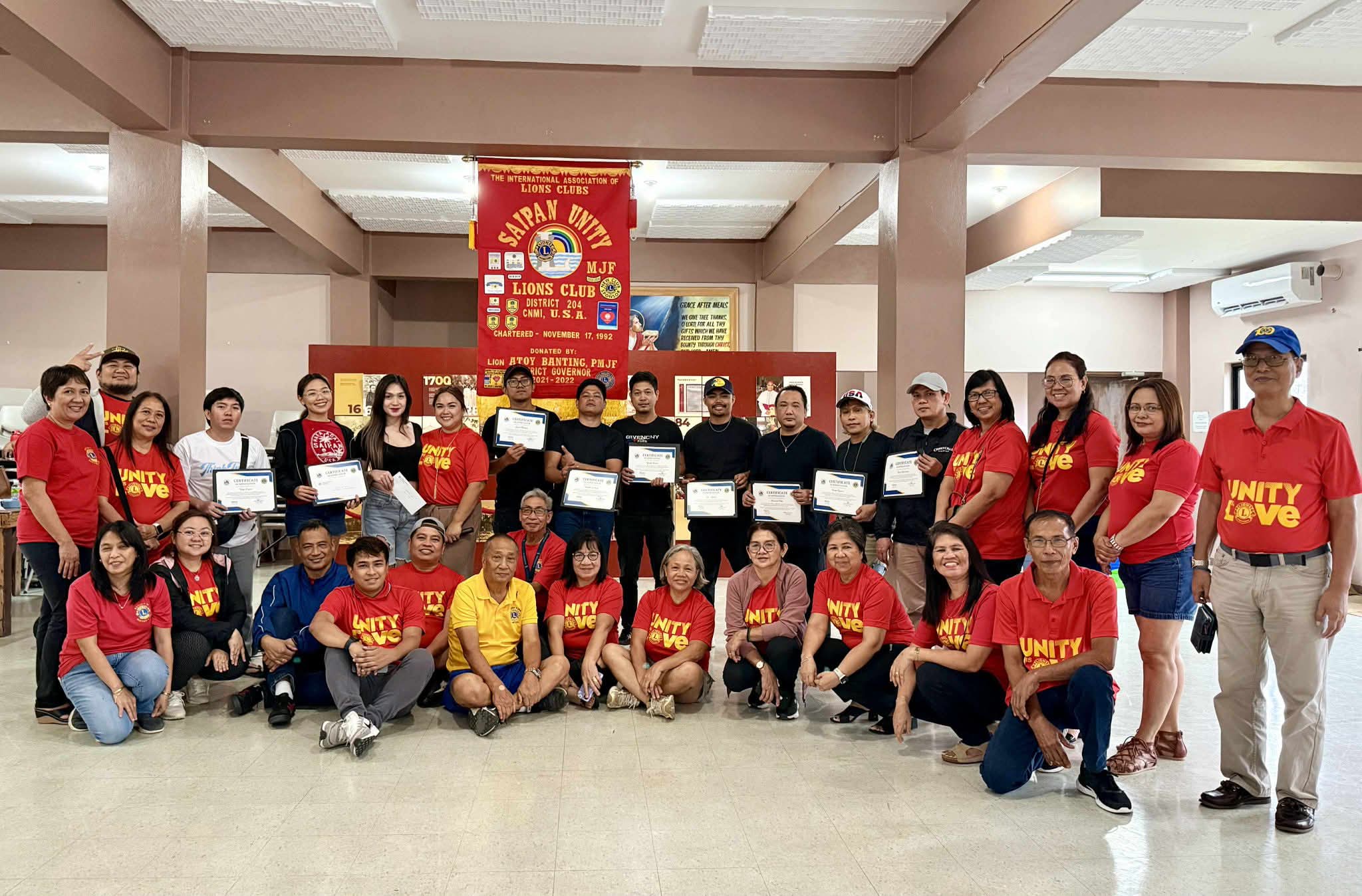 Volunteer hairdressers and barbers receive certificates of appreciation from Saipan Unity Lions Club members.