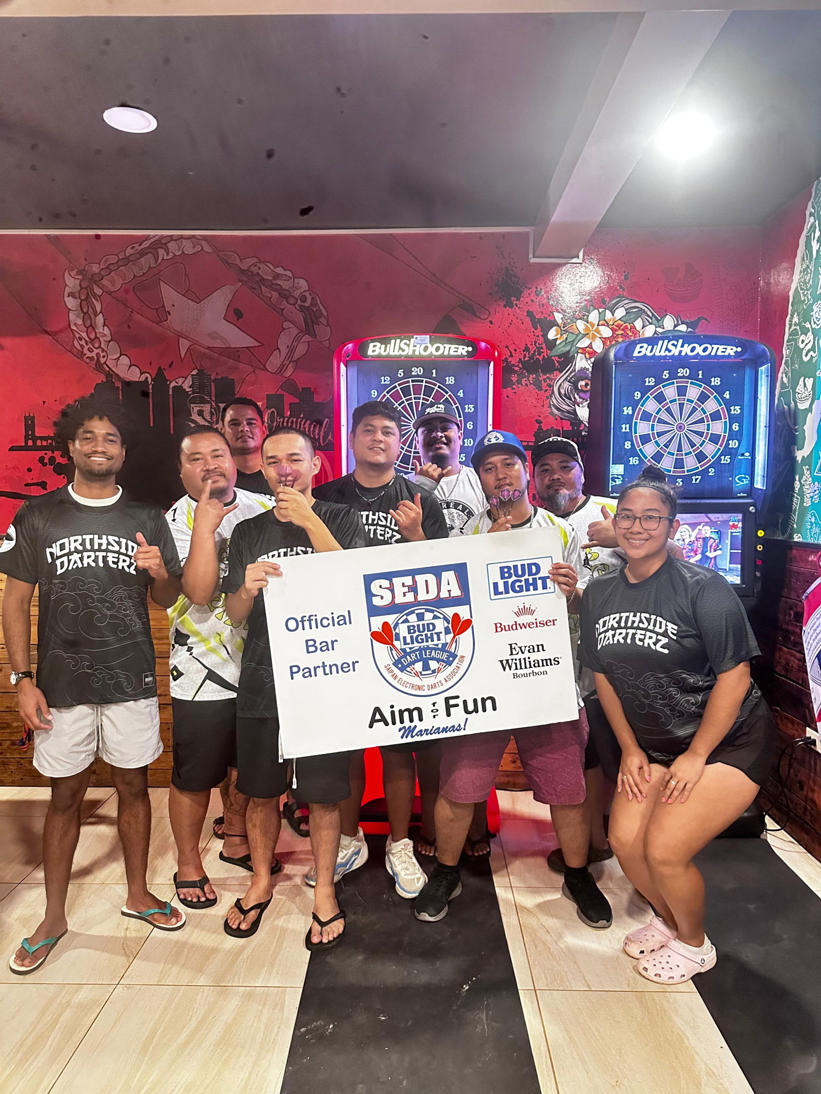Tom Yum Darting Dinanchi players and The Hut North Side Darterz pose for a group photo after their match in the Kingfisher C Division of the 2025 SEDA Bud Light Dart League at The Hut on Wednesday night.Contributed photo