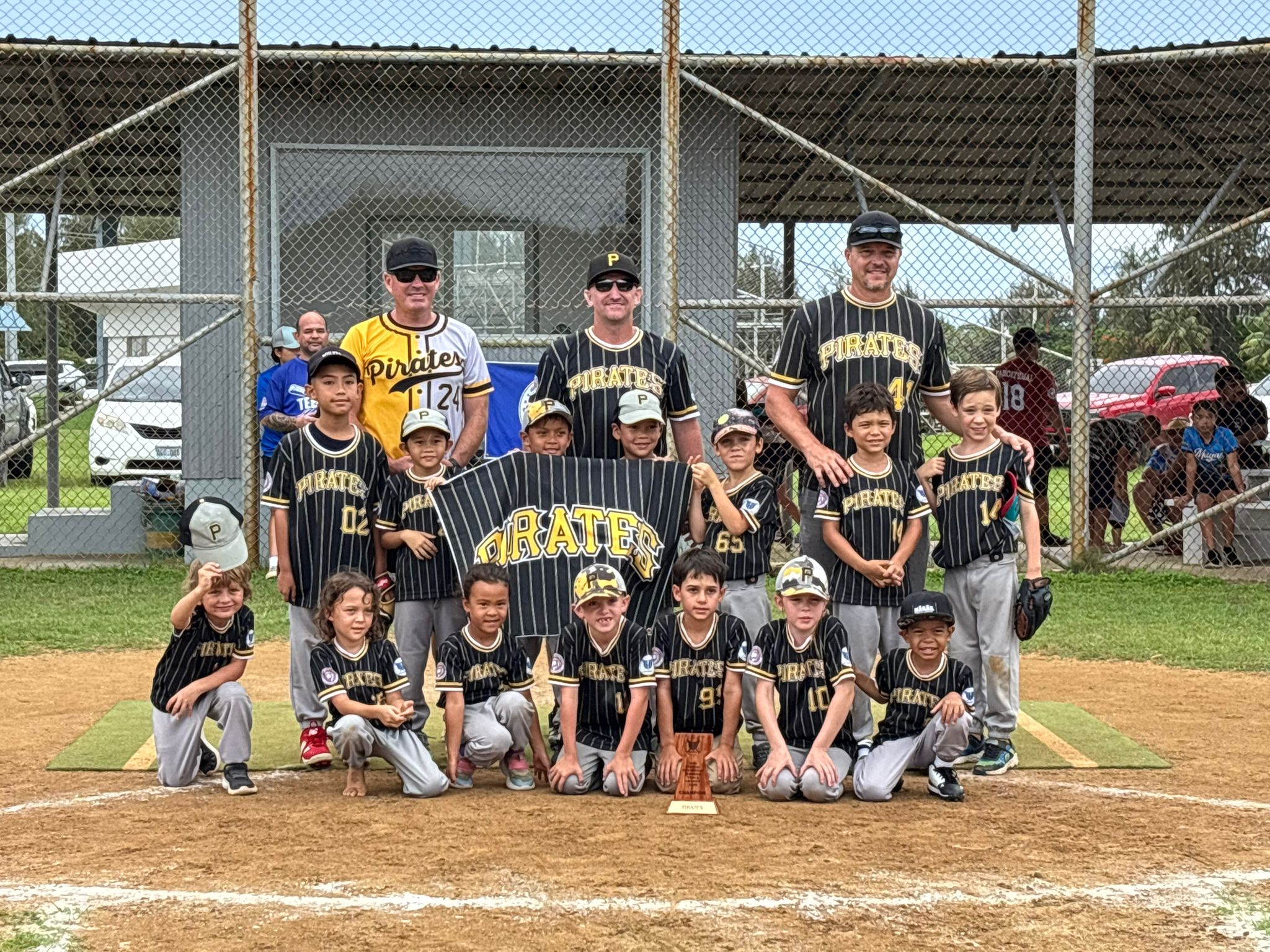 The Pirates pose for a group photo with the championship trophy during the awards ceremony of the NMISA's 2nd Annual Summer T-Ball League 2025 at the Miguel "Tan Ge" Pangelinan Ball Field on Saturday.