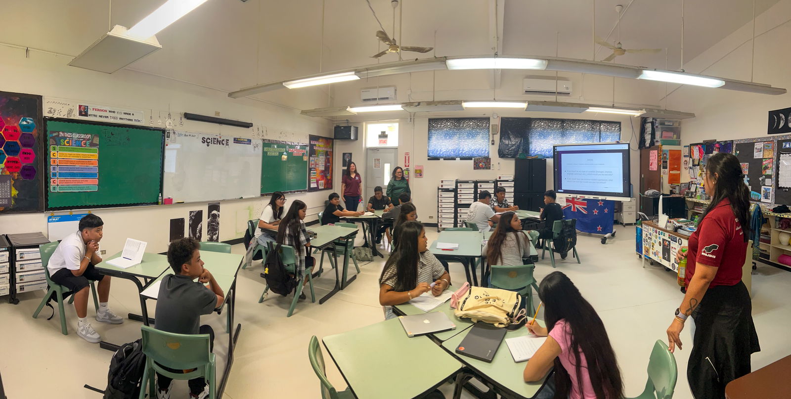 In the Career and Technical Education class at Dr. Rita Hocog Inos Junior Senior High School, educator Deseriee Pendergrass, standing at right, welcomes students back to a classroom equipped with technology-based tools, instructional materials, and newly prepared facilities. The effort is supported by federal programs, local funds, and school-community partnerships. Also pictured are Principal Annette Calvo and PSS Federal Programs Officer Jacqueline P. Che.