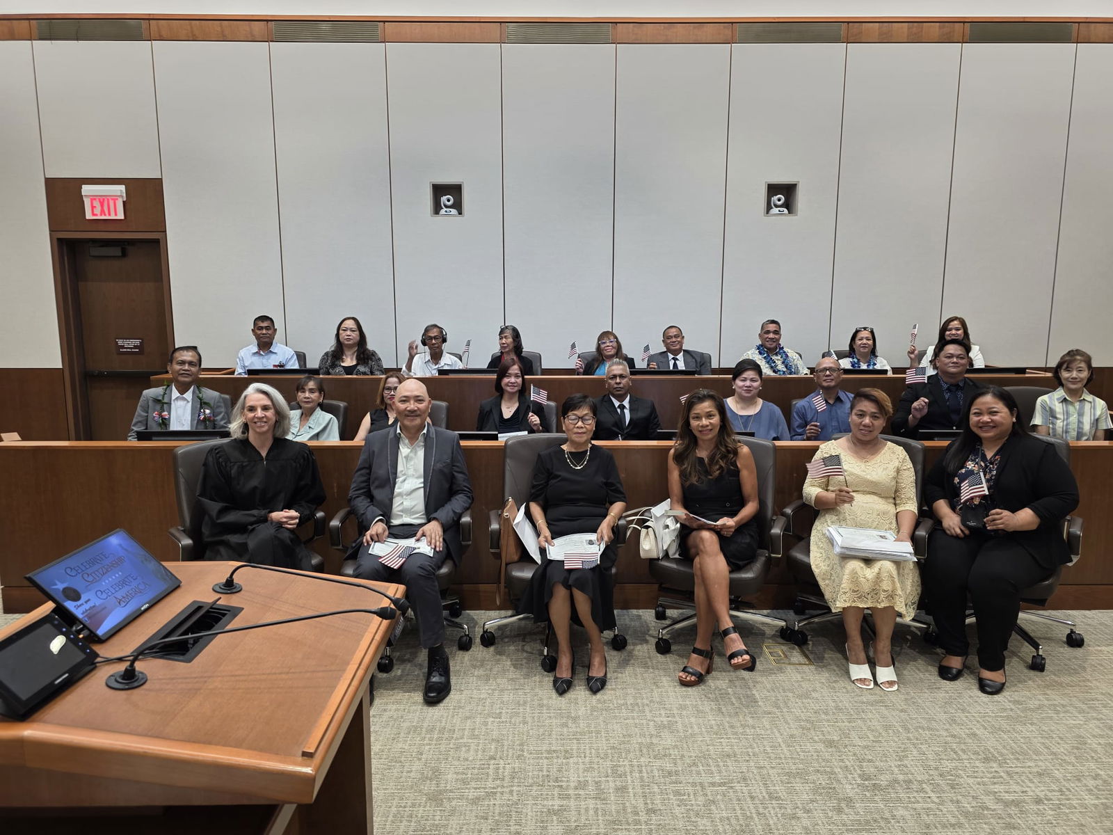 The 22 new U.S. citizens pose for a photo with Magistrate Judge Heather Kennedy and USCIS Officer Brianne Naputi during a naturalization ceremony at the United States Courthouse in Gualo Rao.Photo by Bryan Manabat