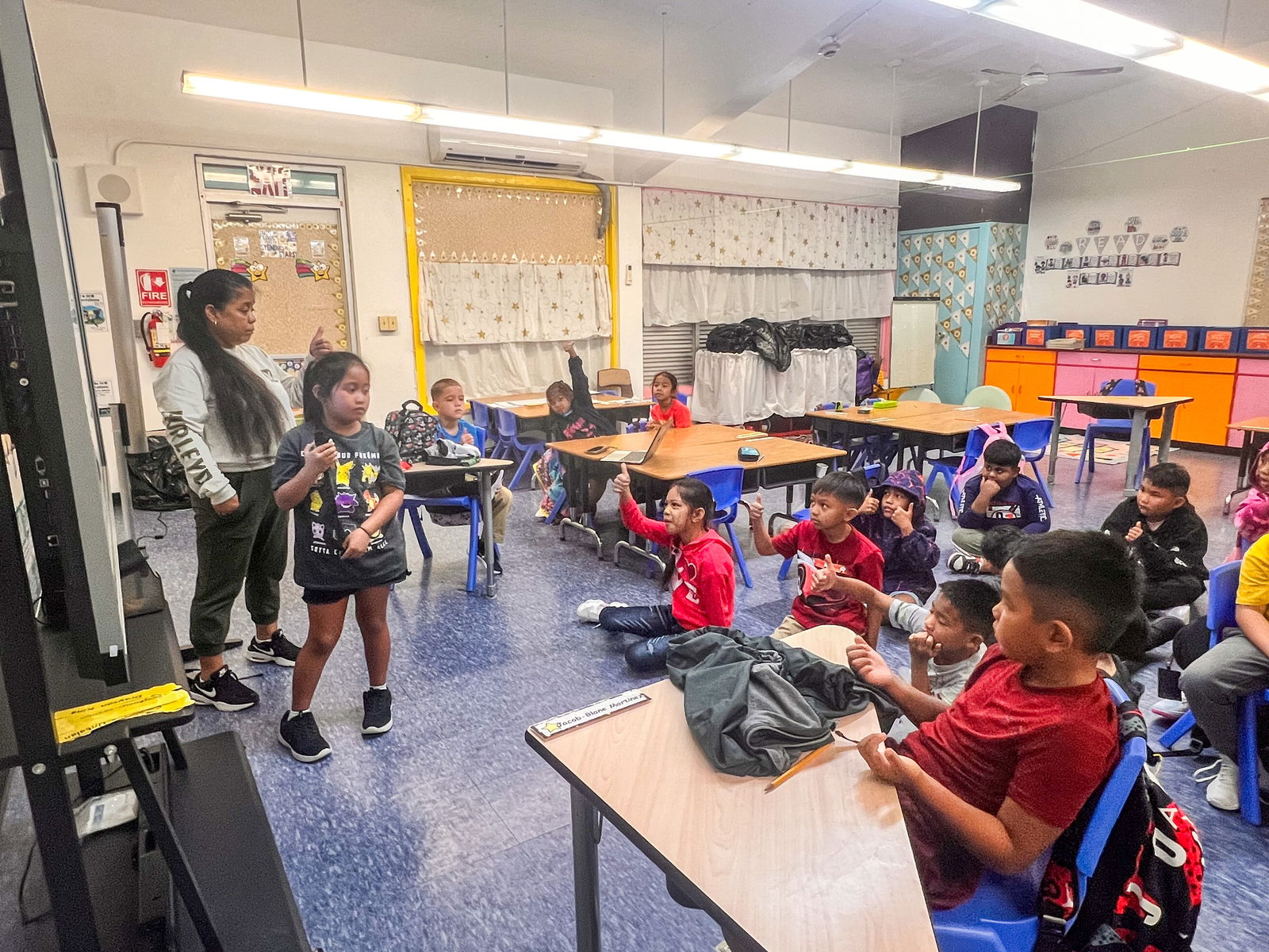 Second graders present their quiz results using an interactive screen, leading the session themselves to enhance learning.