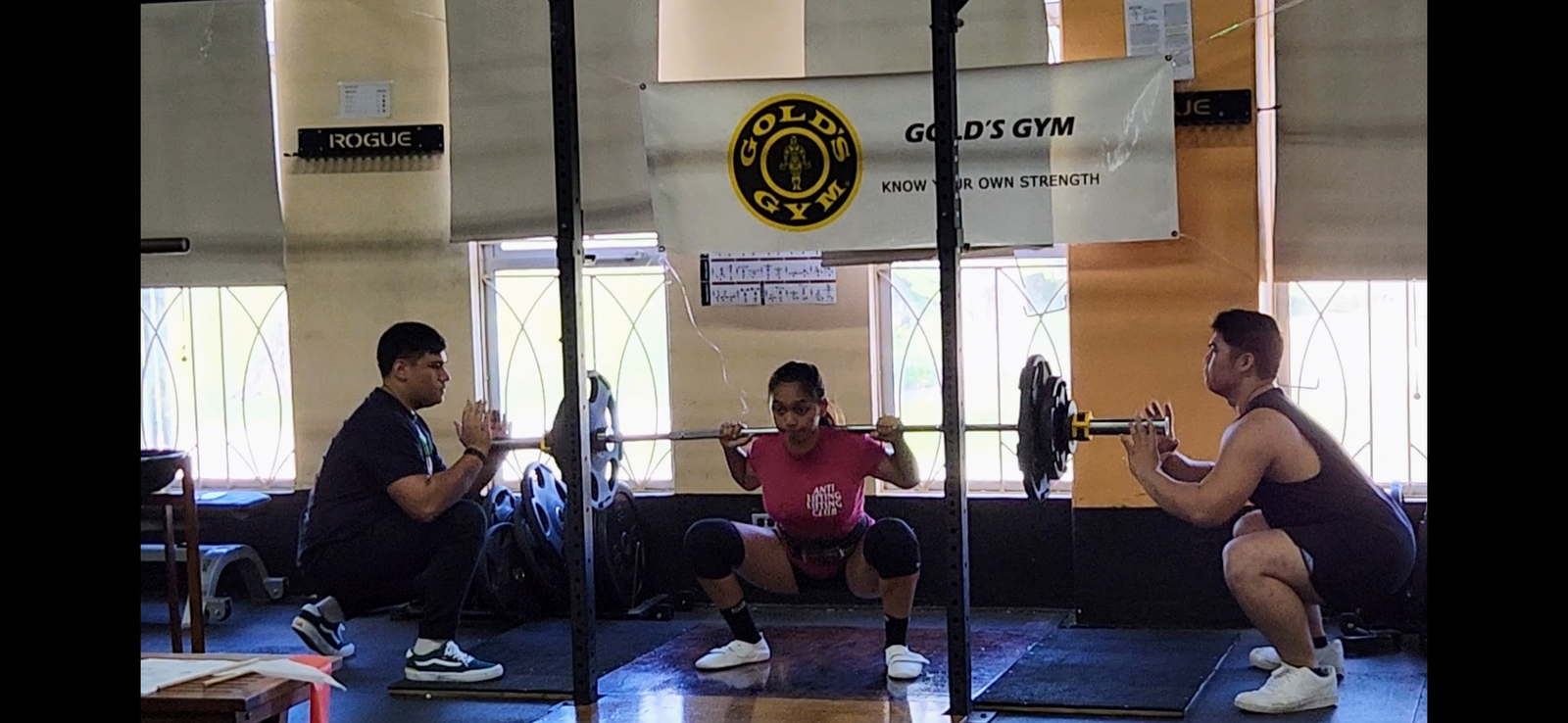 A competitor performs her squat attempt.
