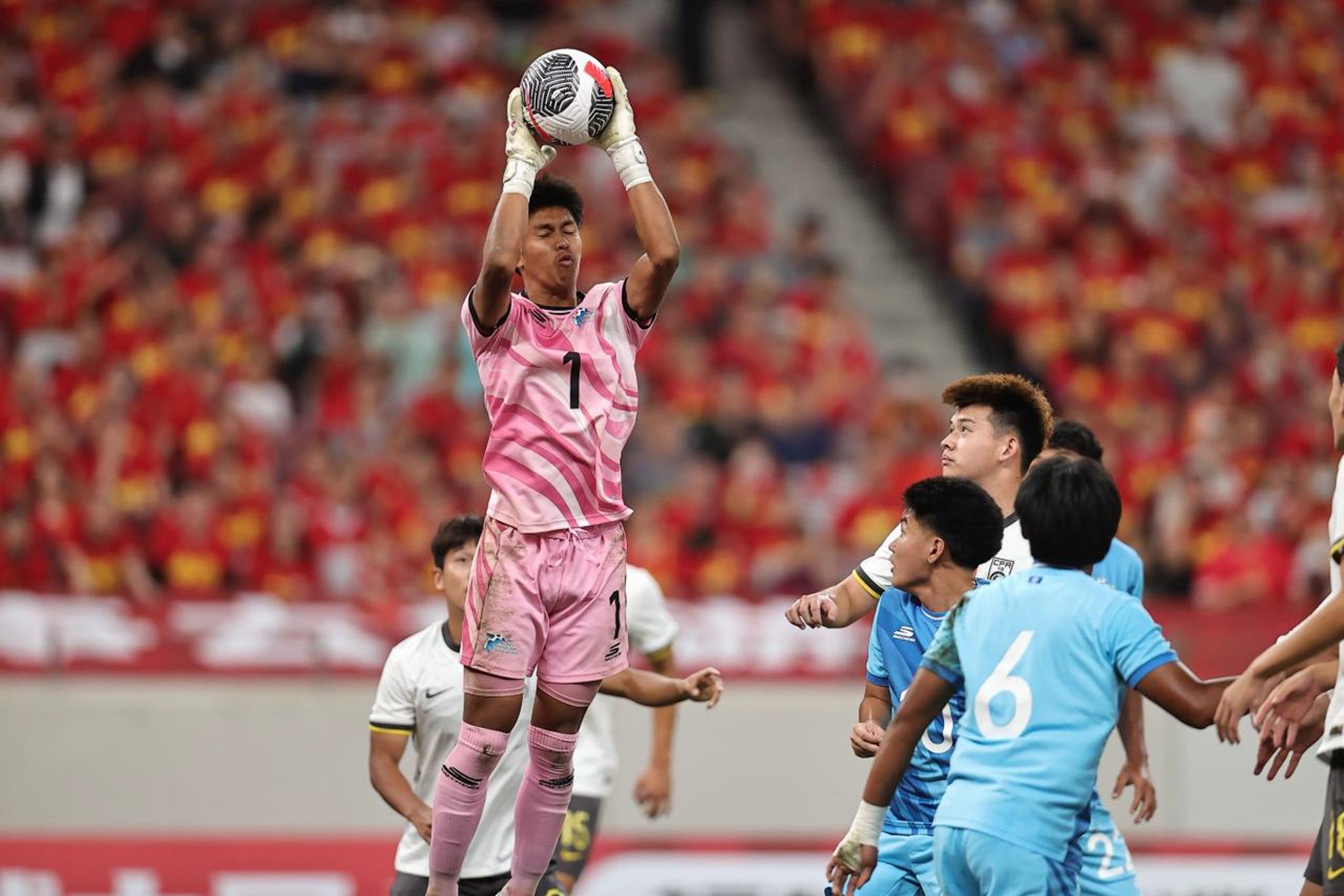 NMI's Merrick Toves secures the ball against China in an AFC U23 Asian Cup Qualifiers match on Saturday in China.
