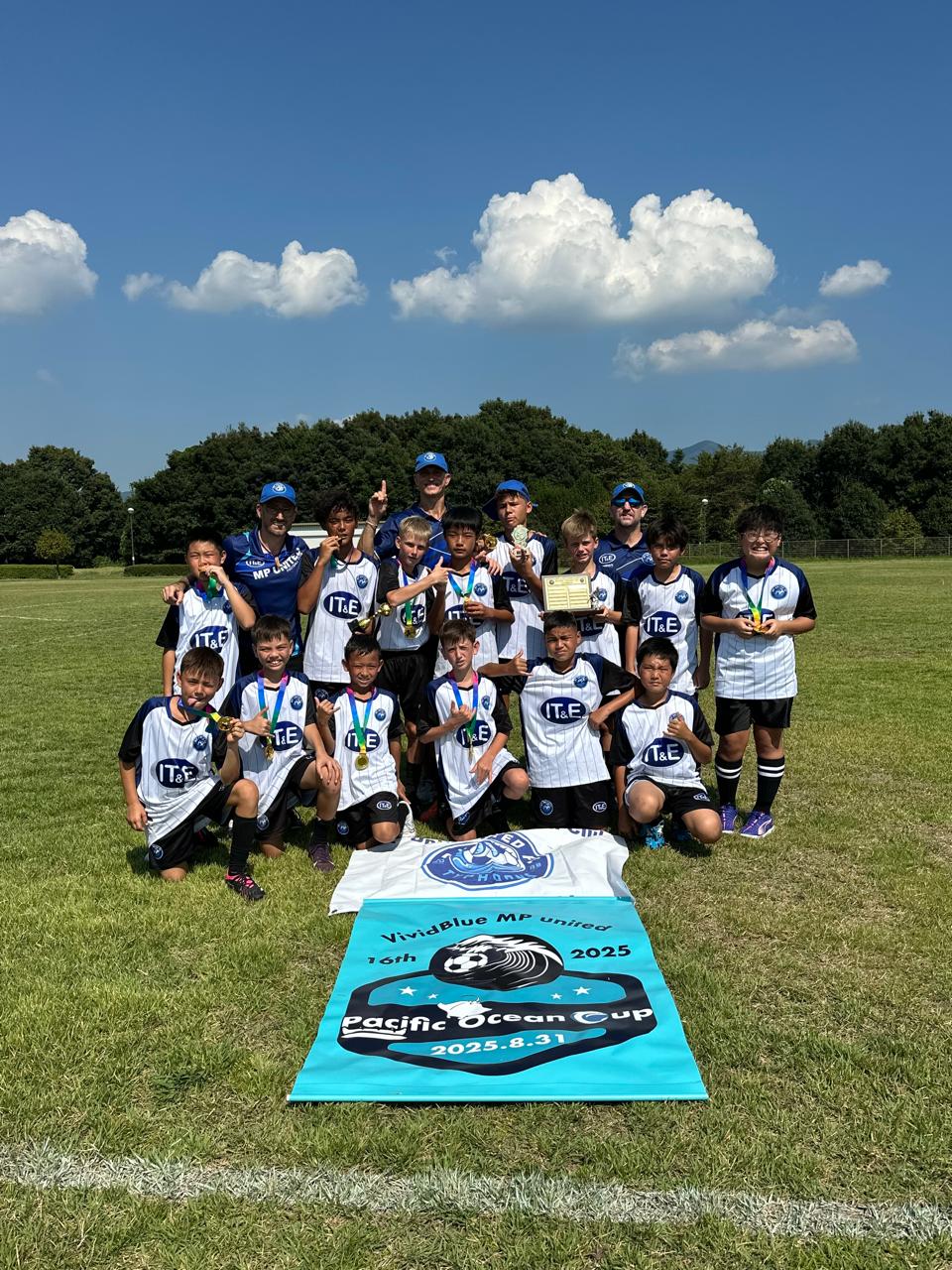 The MP United Boys U13 soccer team members pose for a group photo with the championship trophy of the Pacific Ocean Cup POC XI in Japan on Saturday, Aug. 31, 2025.Contributed photos