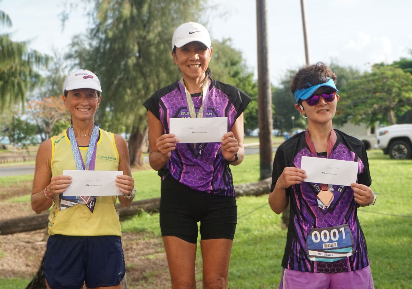 The top three women's division finishers — Krista Hawley, Akiko Miller and An Bang — pose for a photo after completing the Run Saipan Half Marathon 2025 on Saturday morning.