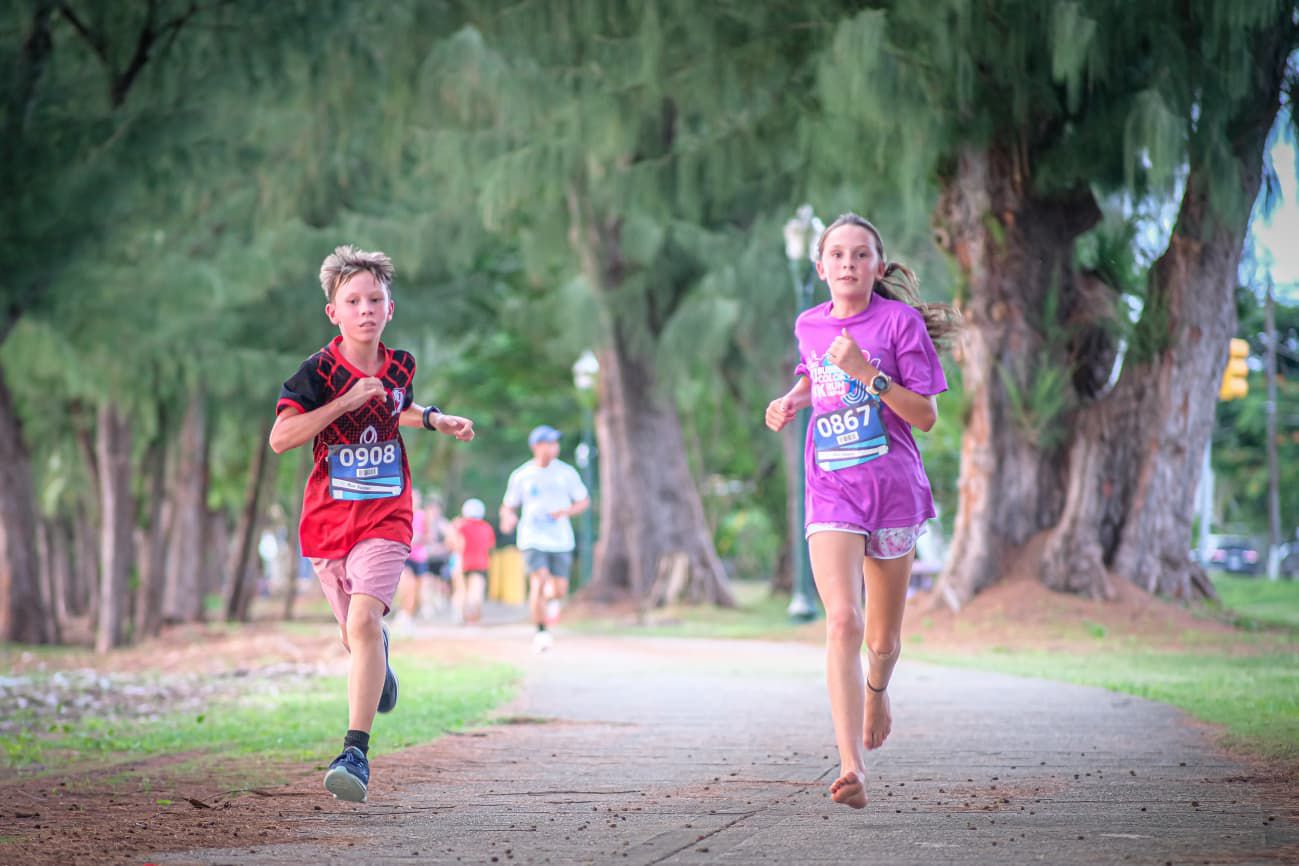 Gabriel Walsh leads the U12 division of the Run Saipan inaugural ASC Trust 401K Day Sunset Strides 5K on Beach Road in Garapan on Friday.