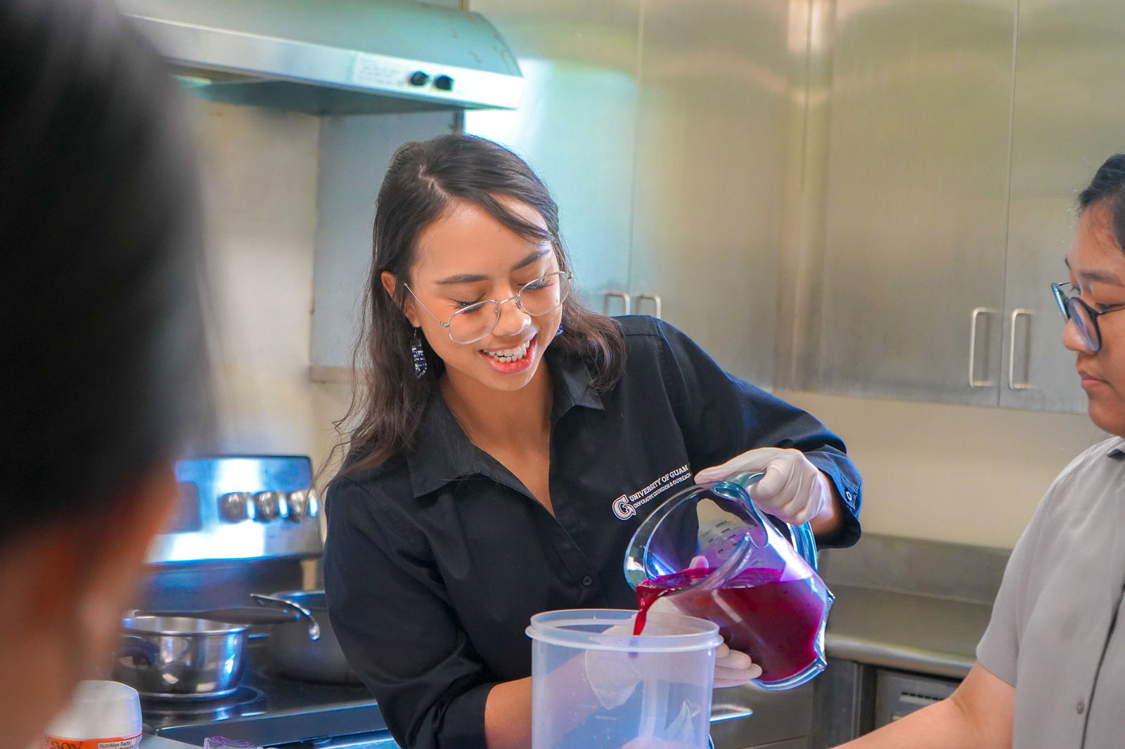 Sophie Santos, an extension associate with UOG Land Grant, pours fresh dragon fruit nectar during a value-added foods workshop held in Sept. 2024. UOG will be offering this workshop again on Sept. 6.