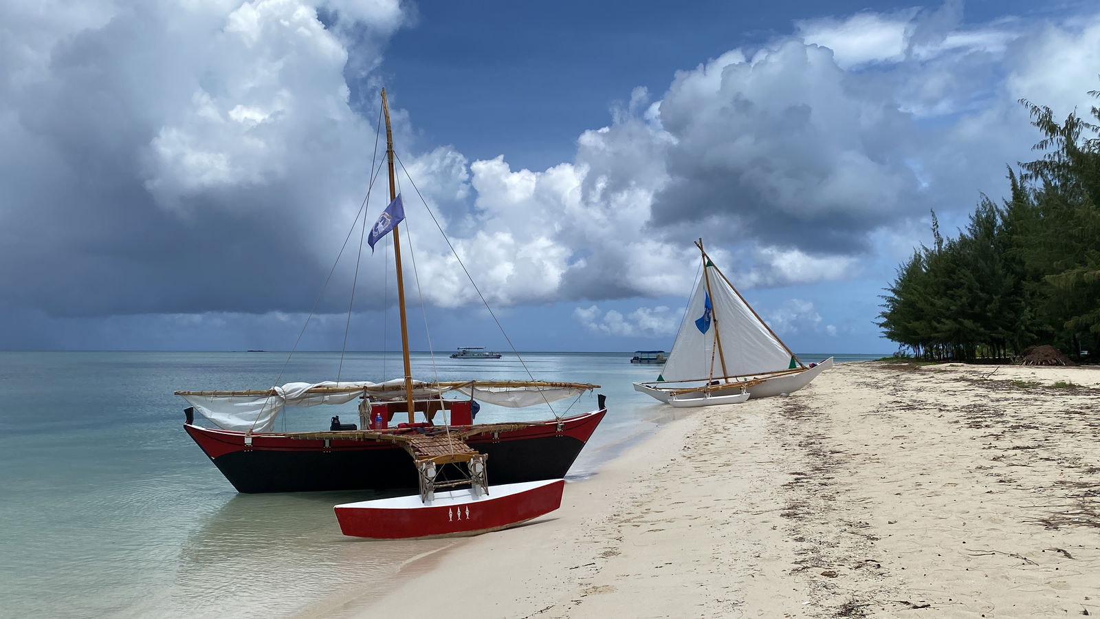Traditional canoes Mikaela, foreground, and Neni sit on the sand after sailing through the Saipan Lagoon, as part of the proclamation signing declaring September Cultural Heritage Month.​