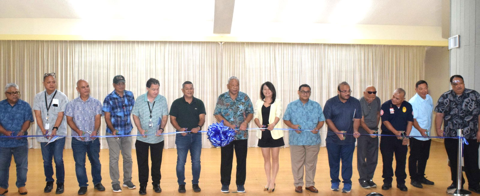 Gov. David M. Apatang, Office of Grants Management and State Clearinghouse Administrator Epi Cabrera Jr., Saipan Green Energy owner Stacy Wang, Rep. Vincent Aldan, and Commonwealth Utilities Corp. Executive Director Kevin Watson along with other officials cut the ceremonial ribbon to mark the activation of a solar power system at the Governor Pedro P. Tenorio Multi-Purpose Center on Friday. 