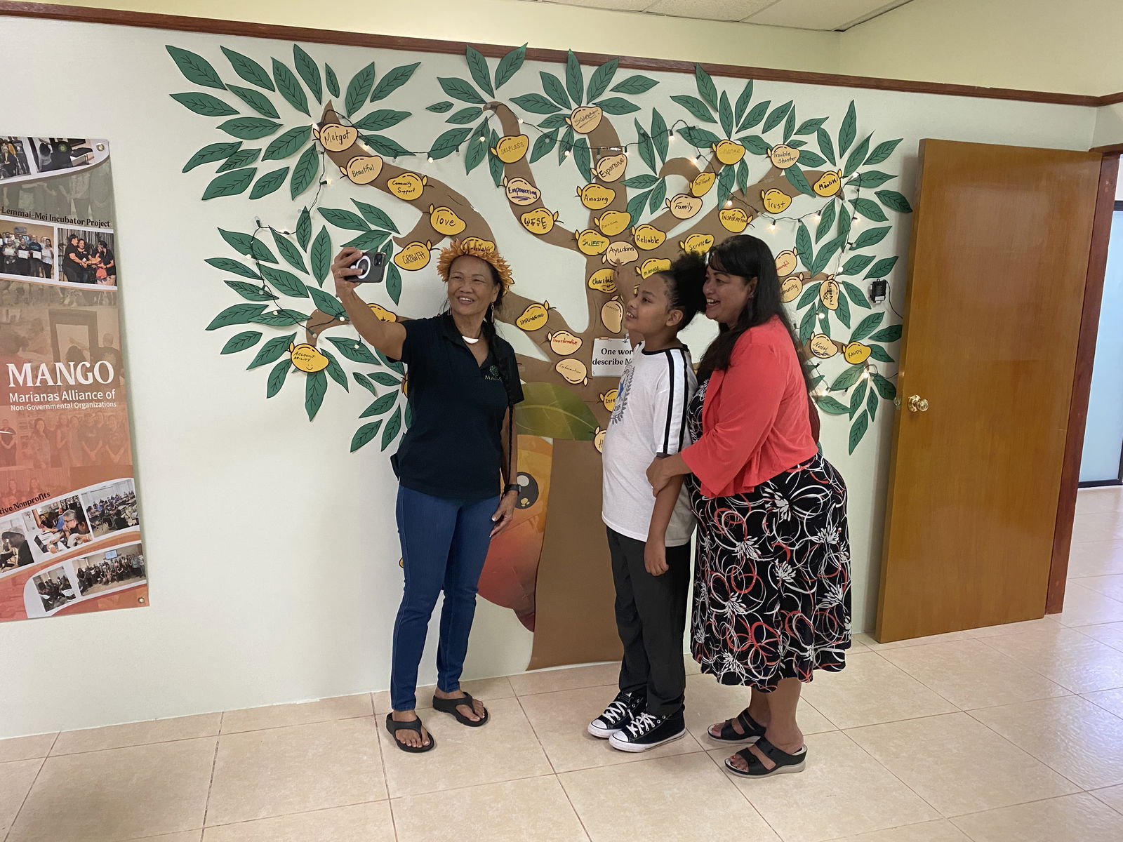 MANGO Executive Director Frances Sablan takes a selfie with community members.