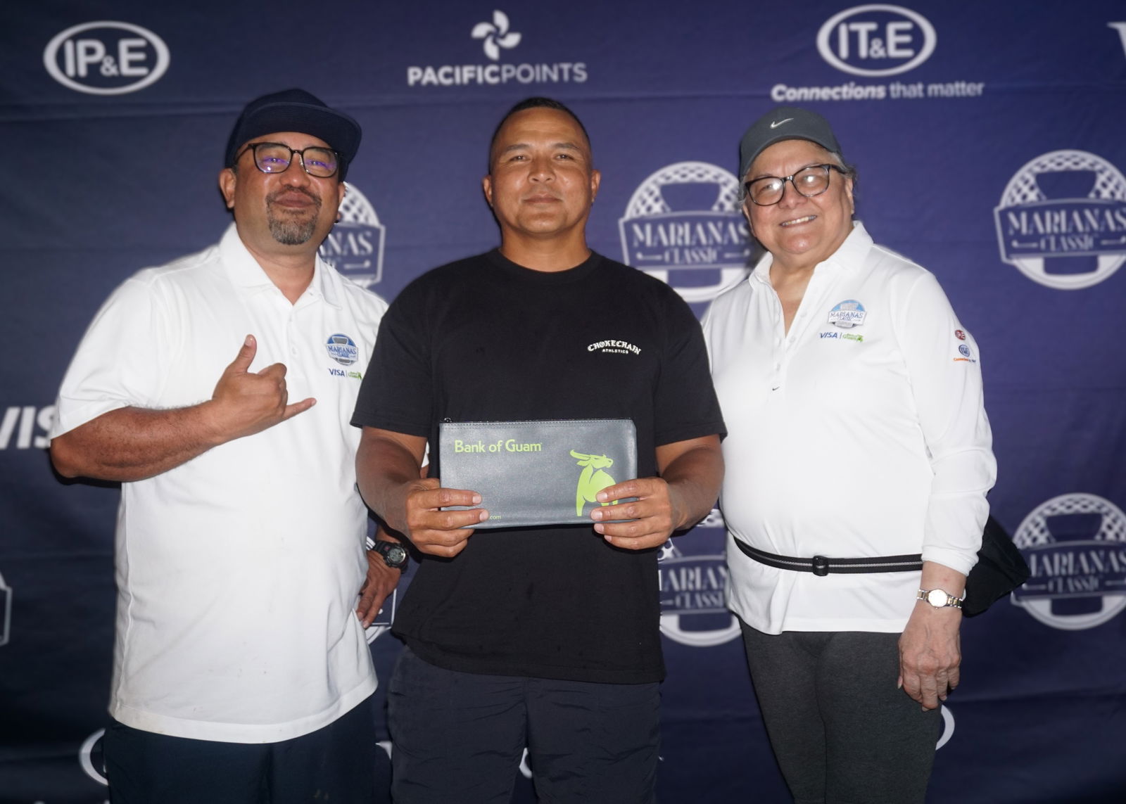 Pete Sablan, who topped the men's Double Peoria category, poses for a photo with Dave Guerrero, Bank of Guam CNMI regional manager, and Marcie Tomokane, BOG vice president/CNMI regional community development officer, during the banquet of the 5th Annual Marianas Classic Golf Tournament at LaoLao Bay Golf & Resort on Saturday.