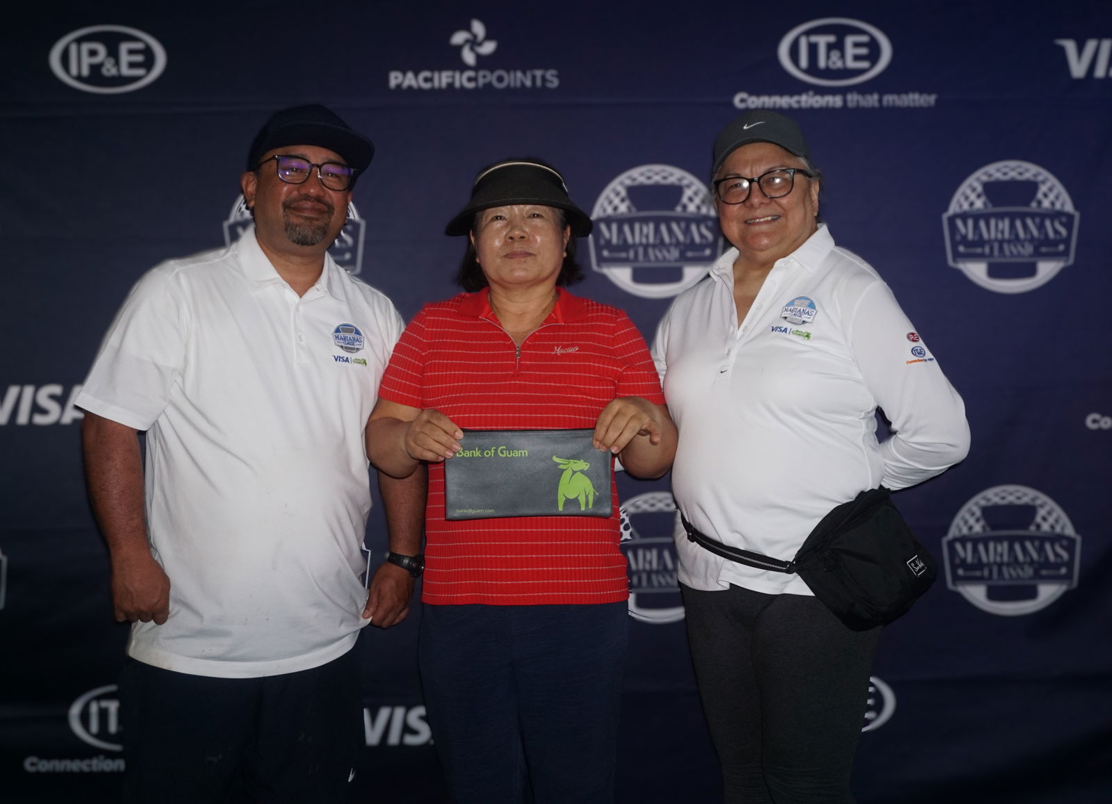 Me Ae Jeon, the women's Low Gross category winner, poses for a photo with Dave Guerrero, Bank of Guam CNMI regional manager, and Marcie Tomokane, BOG vice president/CNMI regional community development officer, during the banquet of the 5th Annual Marianas Classic Golf Tournament at LaoLao Bay Golf & Resort on Saturday.