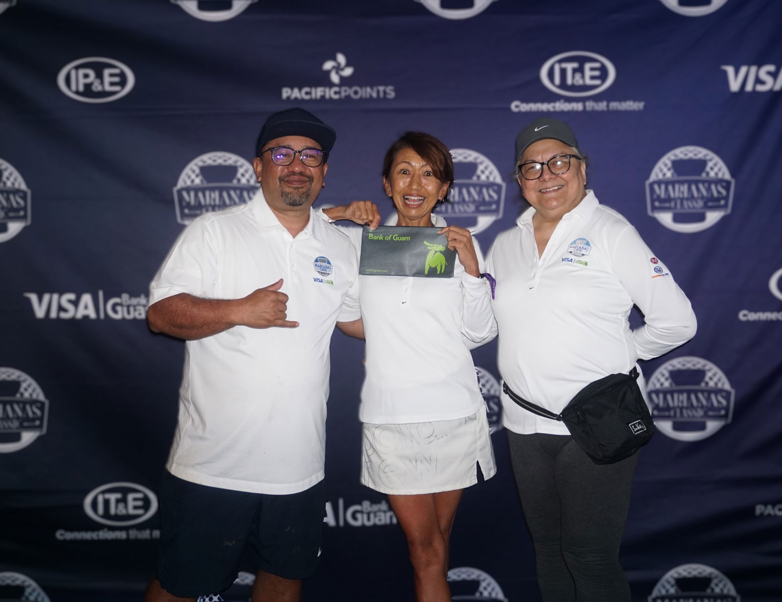 Yuko Togawa, the winner of the women's Double Peoria category poses for a photo with Dave Guerrero, Bank of Guam CNMI regional manager, and Marcie Tomokane, BOG vice president/CNMI regional community development officer, during the banquet of the 5th Annual Marianas Classic Golf Tournament at LaoLao Bay Golf & Resort on Saturday.