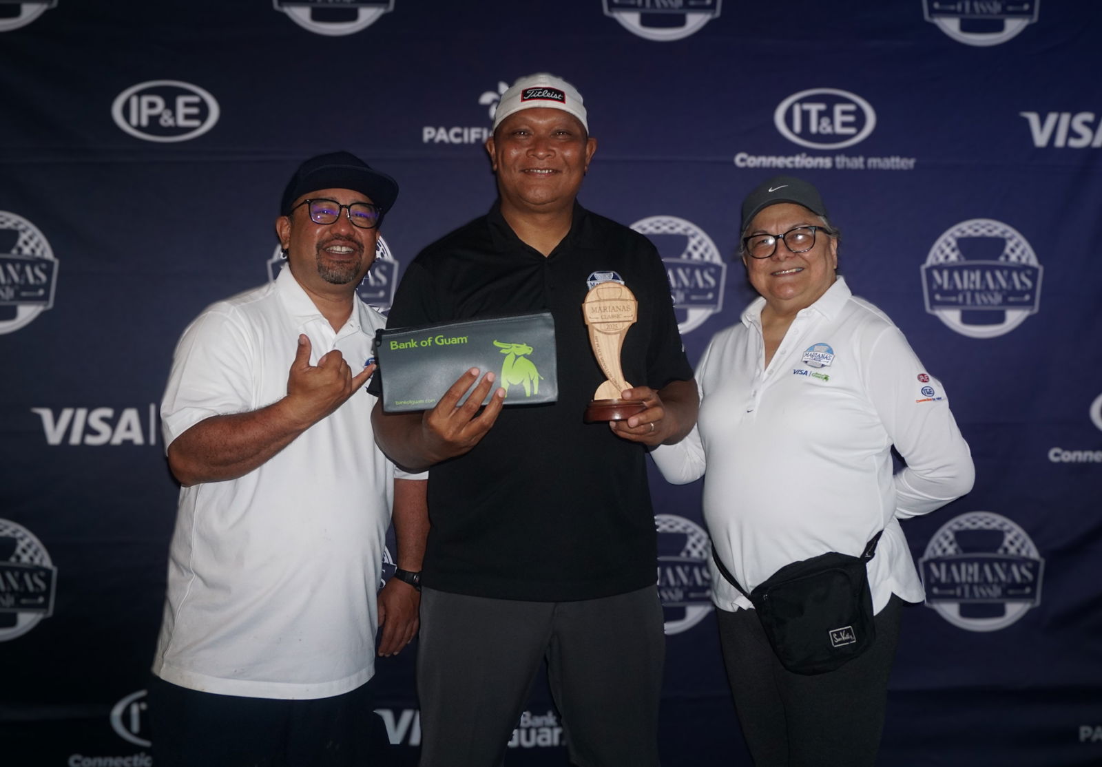 Ned Norita, who placed first in the men's Low Gross category, poses for a photo with Dave Guerrero, Bank of Guam CNMI regional manager, and Marcie Tomokane, BOG vice president/CNMI regional community development officer, during the banquet of the 5th Annual Marianas Classic Golf Tournament at LaoLao Bay Golf & Resort on Saturday.